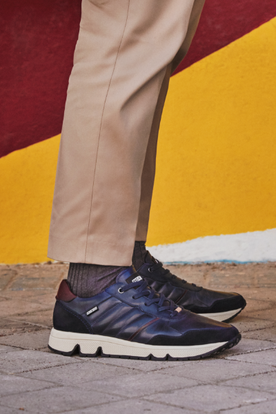 Man standing on sidewalk