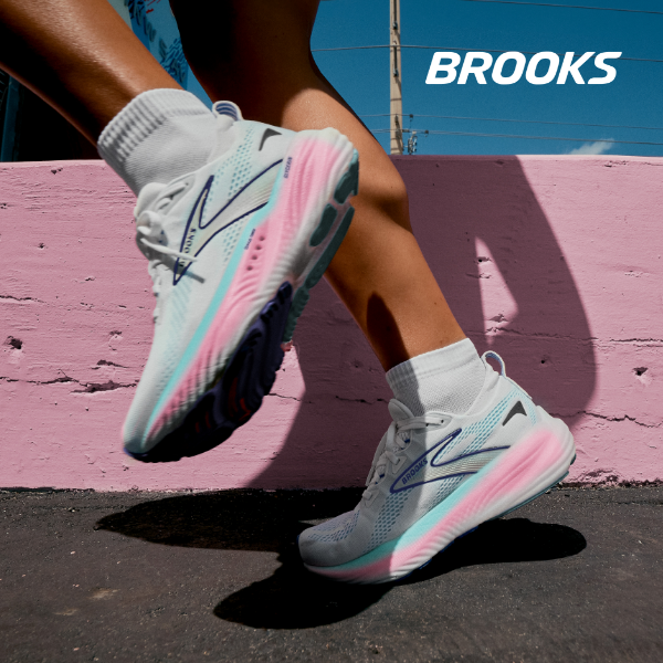 Woman running on sidewalk wearing Brooks