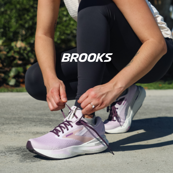 Woman lacing up Brooks Adrenaline shoes