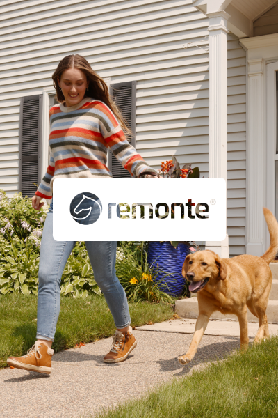 Woman walking dog outside on path 