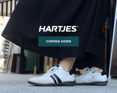 Woman standing on sidewalk in Hartjes sneakers
