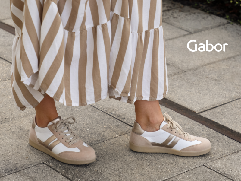 Woman standing on sidewalk in Gabor sneakers