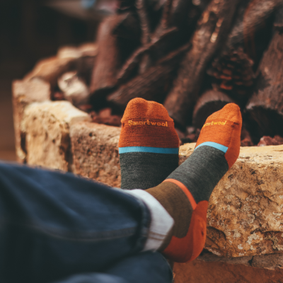 Man sitting with socks on by fire