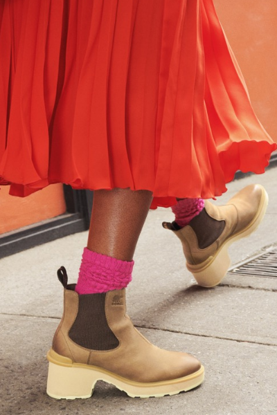 Woman walking on sidewalk