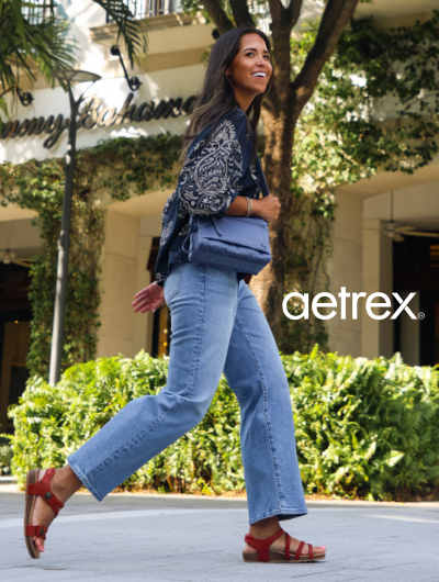 Woman walking across street in Aetrex sandals