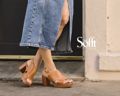 Woman leaning against wall with Sofft sandals on 