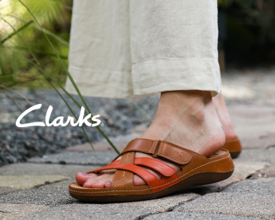 Woman wearing Clarks sandals on sidewalk