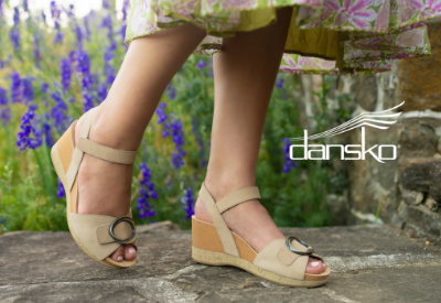 Woman wearing Dansko sandals on sidewalk
