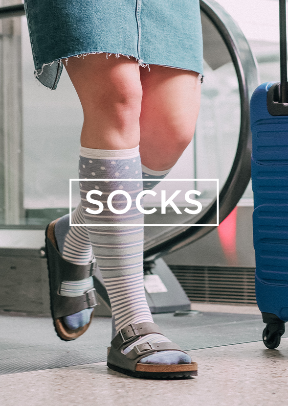 Woman wearing socks and sandals walking in airport