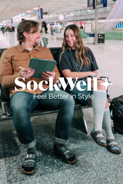 Man and woman sitting in chairs at airport