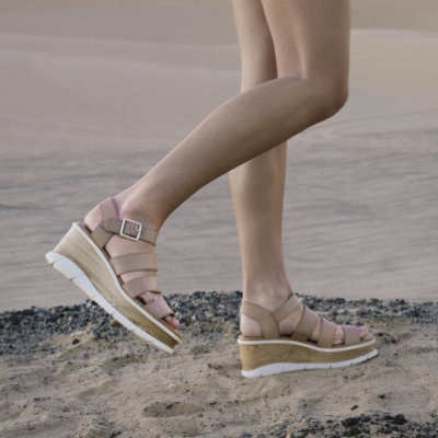 Woman walking in sand dunes