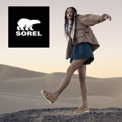 Woman standing on sand dune