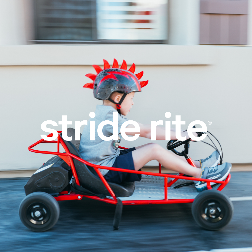 Boy riding go kart on race track