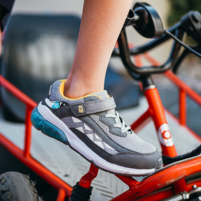 Boy propping foot up on go kart