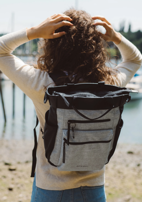 Woman looking at a view wearing a Sherpani travel backpack