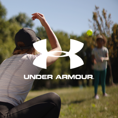 Woman throwing ball in Under Armour shoes 