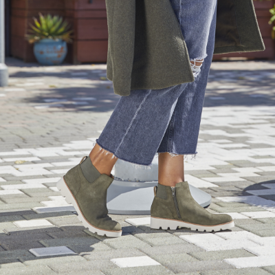 Woman posing feet on sidewalk 