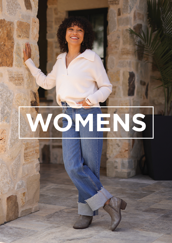 woman wearing boots leaning against pillar